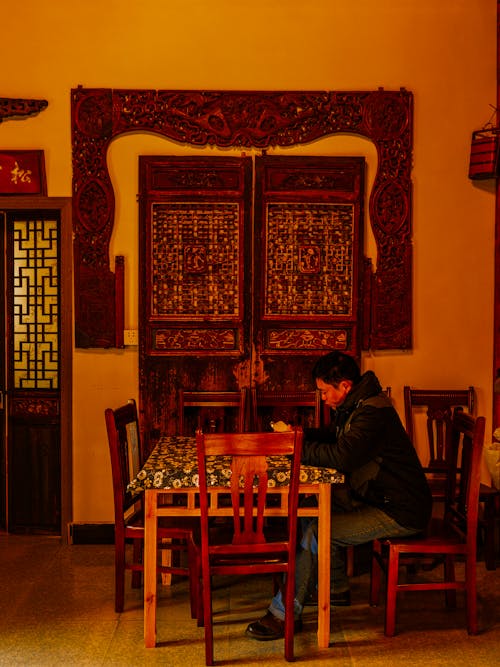 Man sitting on a Wooden Chair 