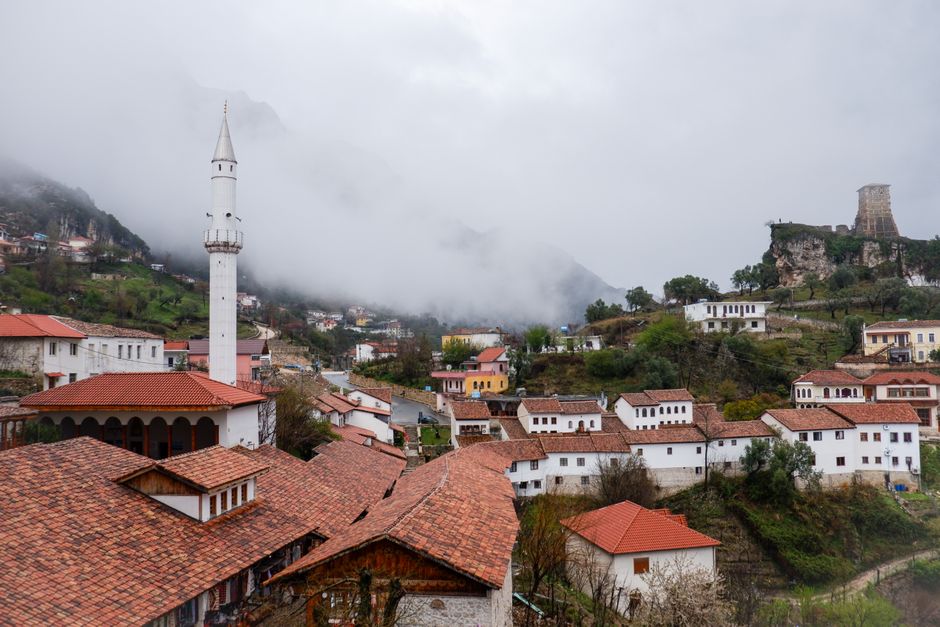 Cobblestone street in Gjirokastër old town, Albania, with traditional stone guesthouses