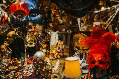 Free Vibrant array of Venetian masks and decorations in a cozy indoor setting. Stock Photo