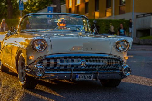 Free Vintage beige Buick convertible captured in golden hour on city street. Stock Photo