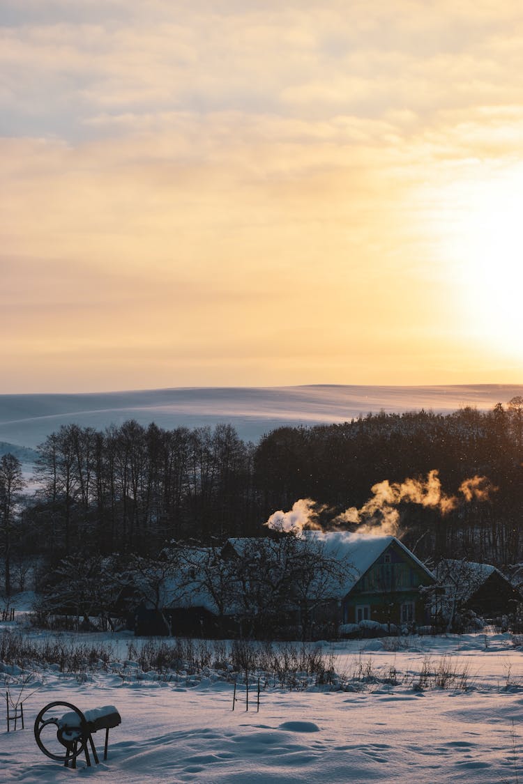 House In Winter Countryside On Sunset