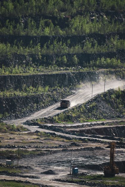 Dust road cutting through a rock quarry, photo by Artem Makarov on Pexels