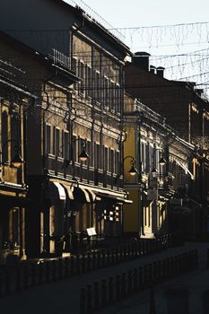 A picturesque old town street with vintage lamp posts during twilight, showcasing historic architecture.