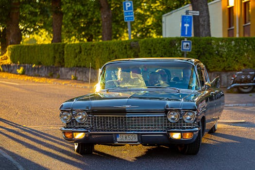 A vintage car captured during a scenic golden hour drive in a picturesque street.