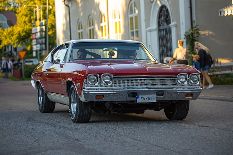 Red Chevrolet Chevelle On Road