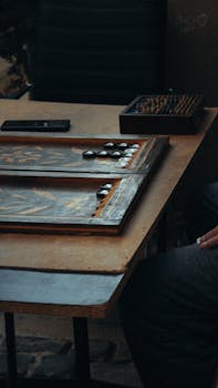 A close-up of a traditional backgammon board on a wooden table, capturing a classic gameplay moment.