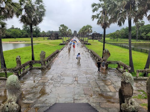 People Walking Along the Stone Footpath in Angkor Wat