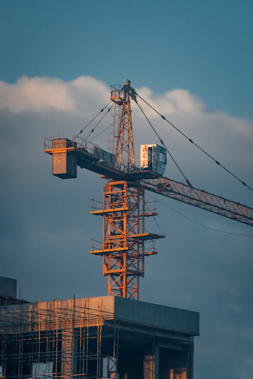 Blue and Orange Crane Under Blue Sky