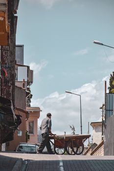 Man with a Trolley on a City Street