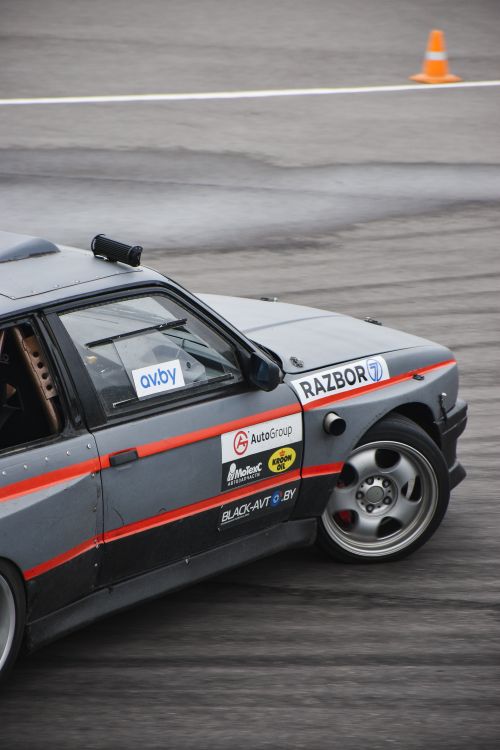 Free Close-up of a racing car drifting on a track during a motorsport event. Stock Photo