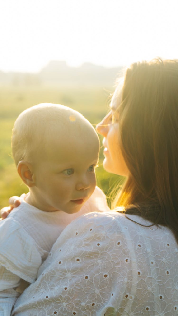 A Woman Carrying A Baby 