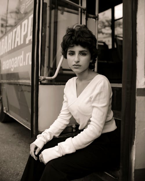 Woman Sitting on Bus Steps