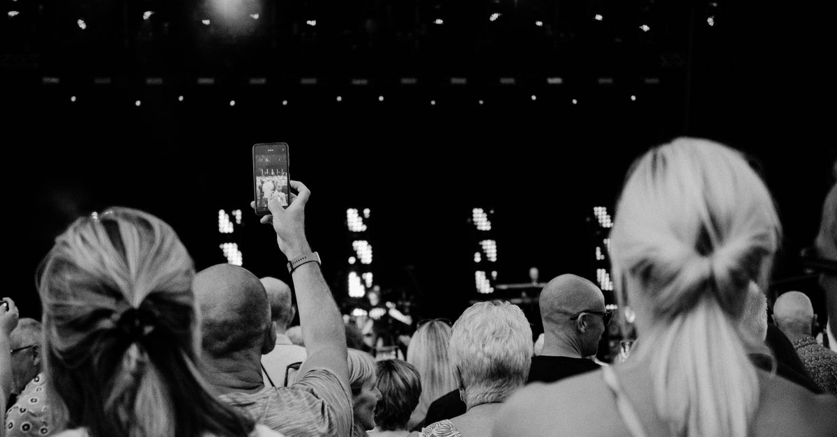 concert crowd with phones and stage lights