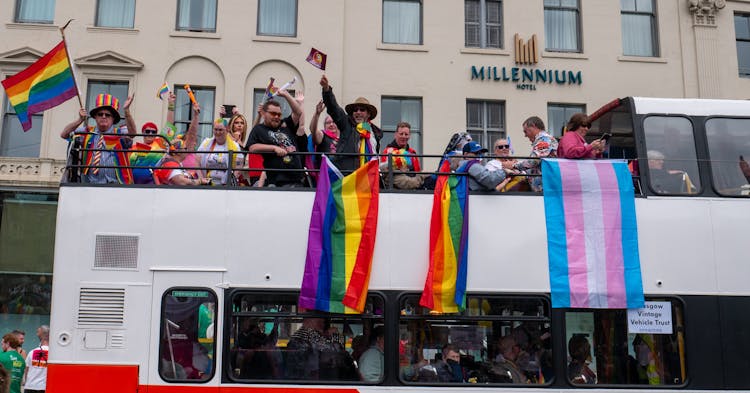 People Riding A Bus On A Parade