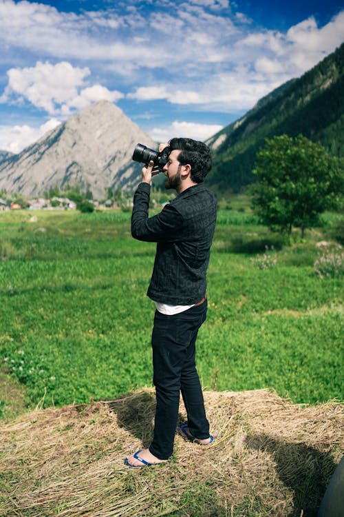 Man Taking Photos in a Mountain Valley 