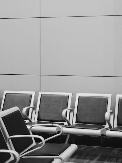 A Grayscale of Chairs in a Waiting Area