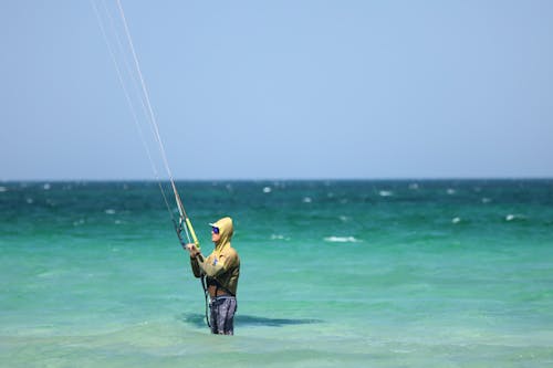 A Man Kite Surfing on the Sea