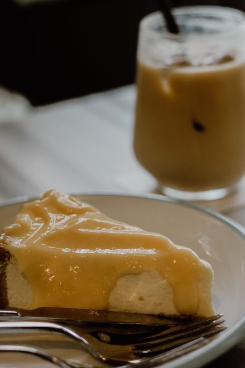 Free A mouthwatering lemon cheesecake paired elegantly with a refreshing iced coffee in Istanbul. Stock Photo