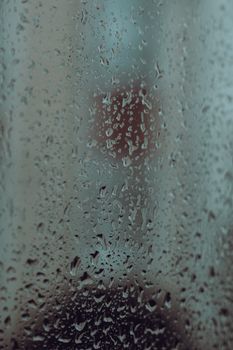 Close-up of water droplets on a glass window with an urban Istanbul backdrop.