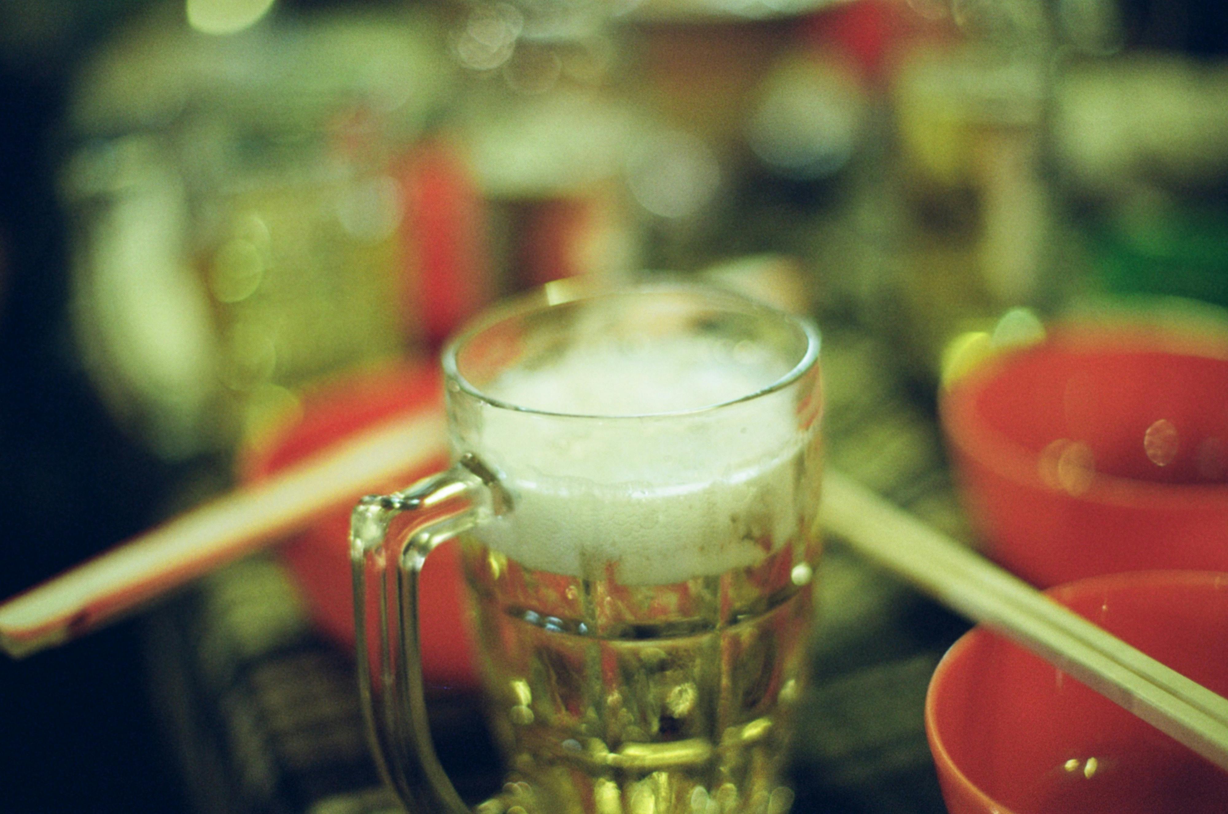 salted caramel cold foam cold brew recipe - Foamy beer in a glass mug on a colorful party table setting, indoors.