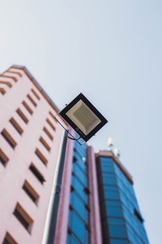 Street light against modern buildings in São Paulo, Brazil under blue sky.