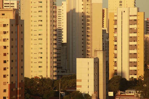 A view of high-rise residential buildings with warm sunset light casting shadows.