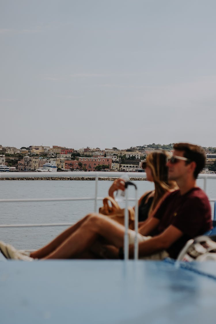 Couple Sitting Near Sea At Beach