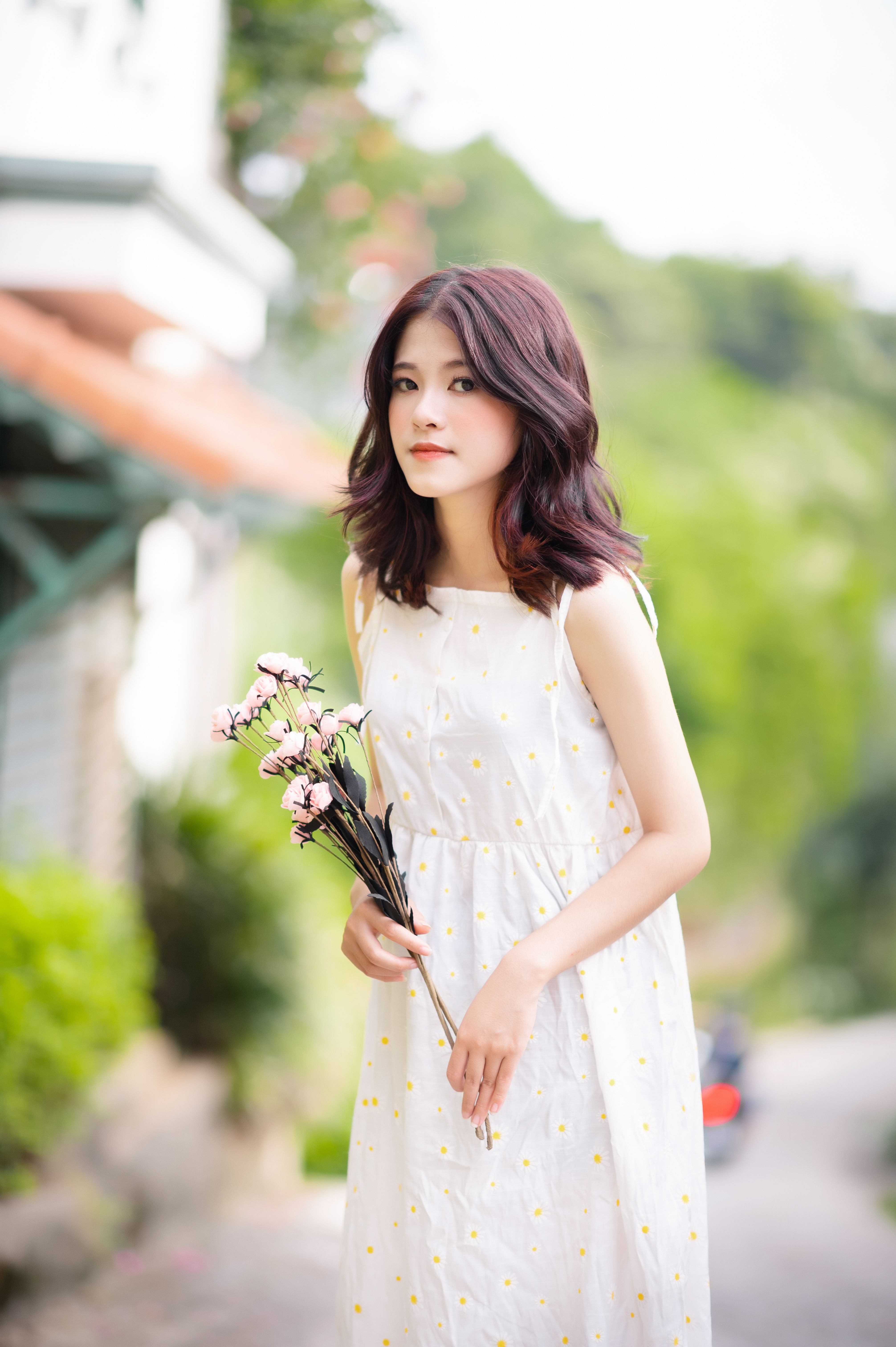 Woman in White Floral Dress Holding a Bunch of Flowers · Free Stock Photo