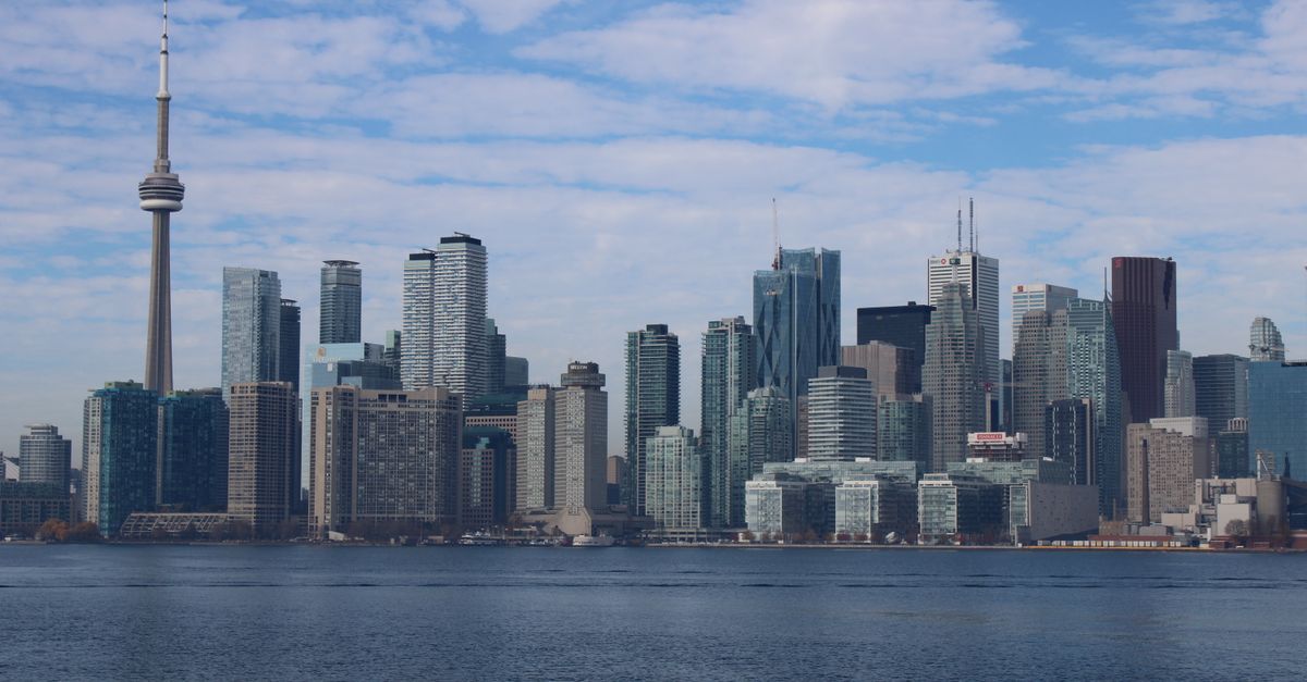Toronto condo towers along the skyline, where pricing a unit to sell follows different math than a detached home