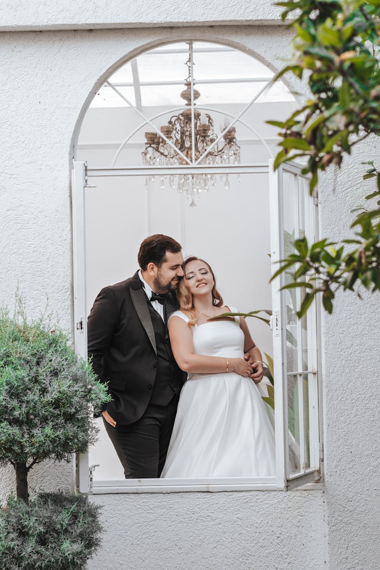 Bride And Groom In House Window