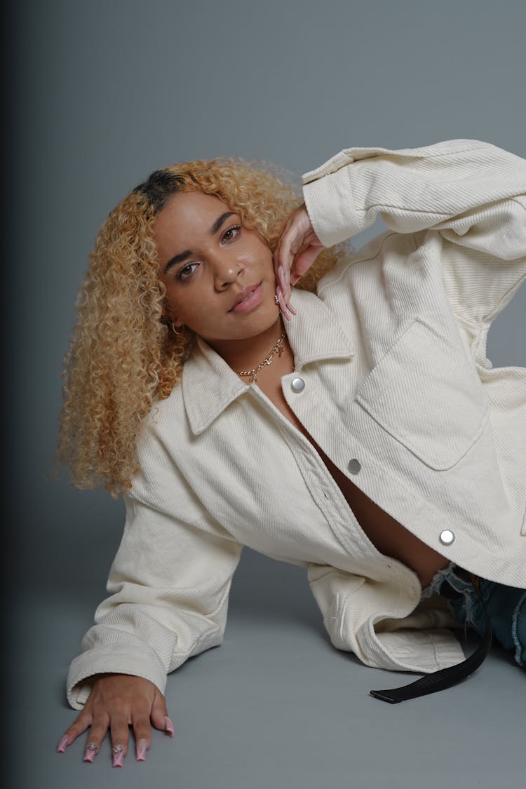 Curly Haired Woman In White Denim Jacket 