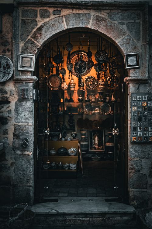Free Charming antique shop entrance with rustic decor and warm interior lighting. Stock Photo