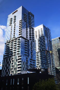 Stunning view of modern skyscrapers in Montreal, highlighting urban architecture against a clear blue sky.