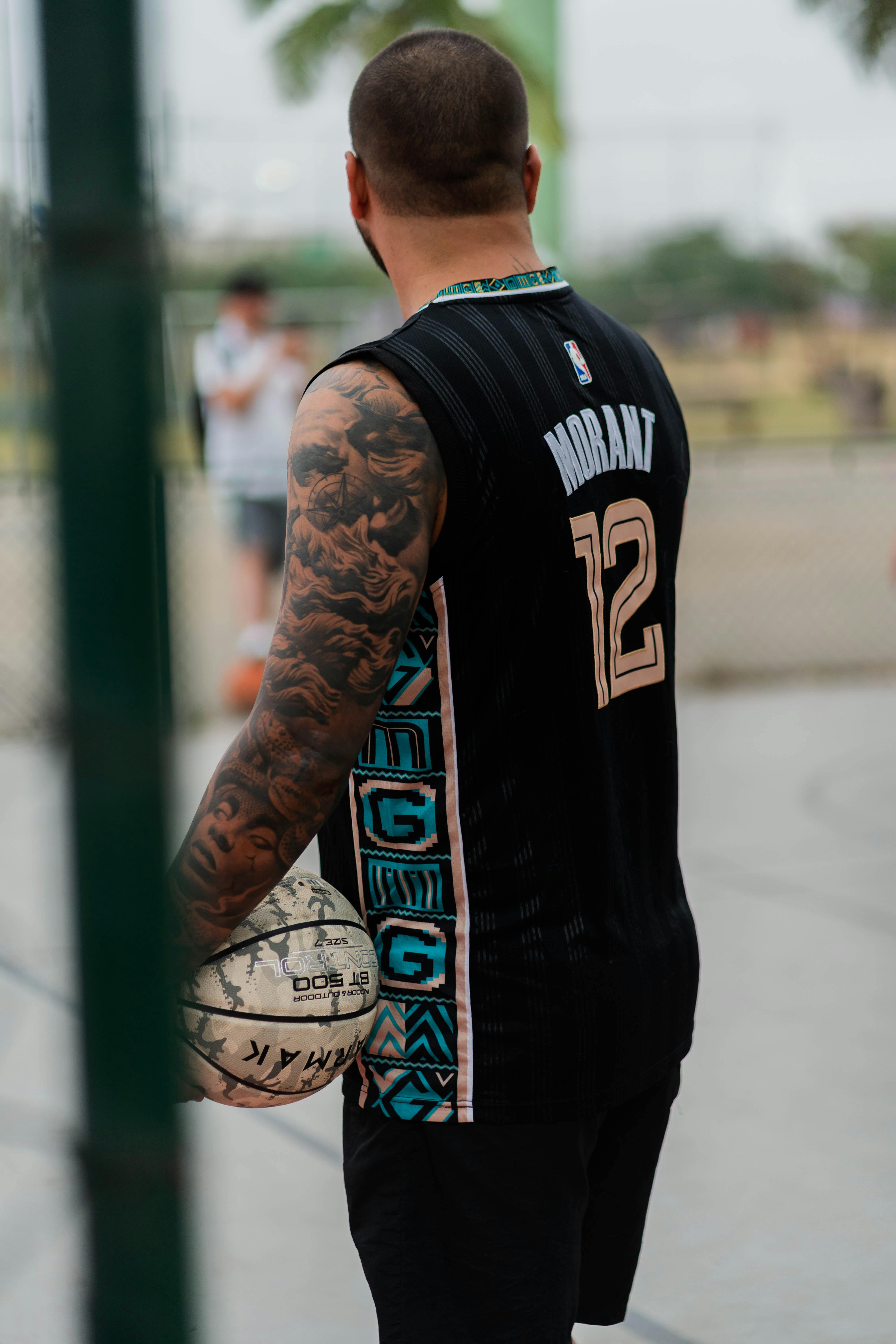 Man Wearing Jersey Holding a Ball · Free Stock Photo
