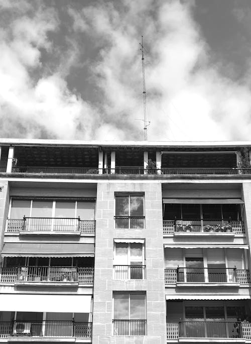 Free Grayscale Photo of Concrete Building with Balconies  Stock Photo