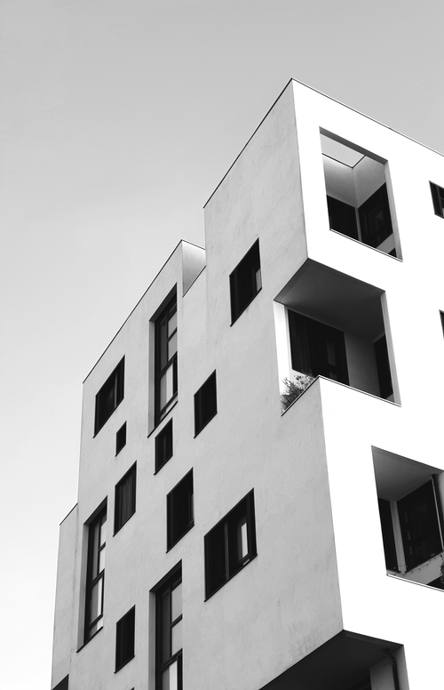 Free Grayscale photo of a modern building with geometric shapes and glass windows in Paris. Stock Photo