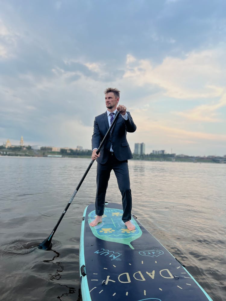 Man In Suit Paddleboarding