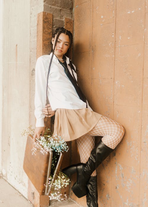 Fashionable Girl Holding a Briefcase with Flowers 