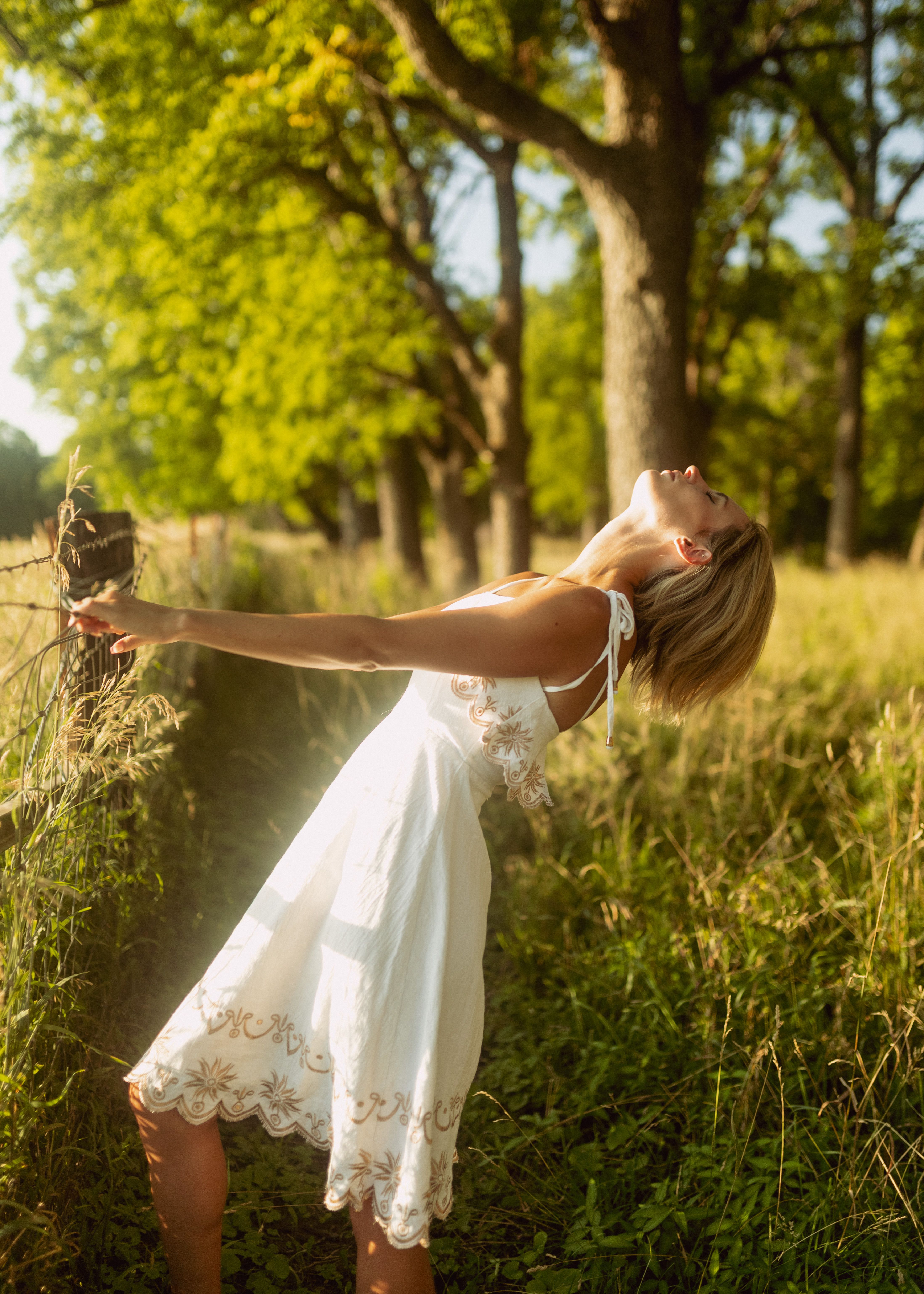 Woman in White Dress Holding on a Barbed Wire · Free Stock Photo