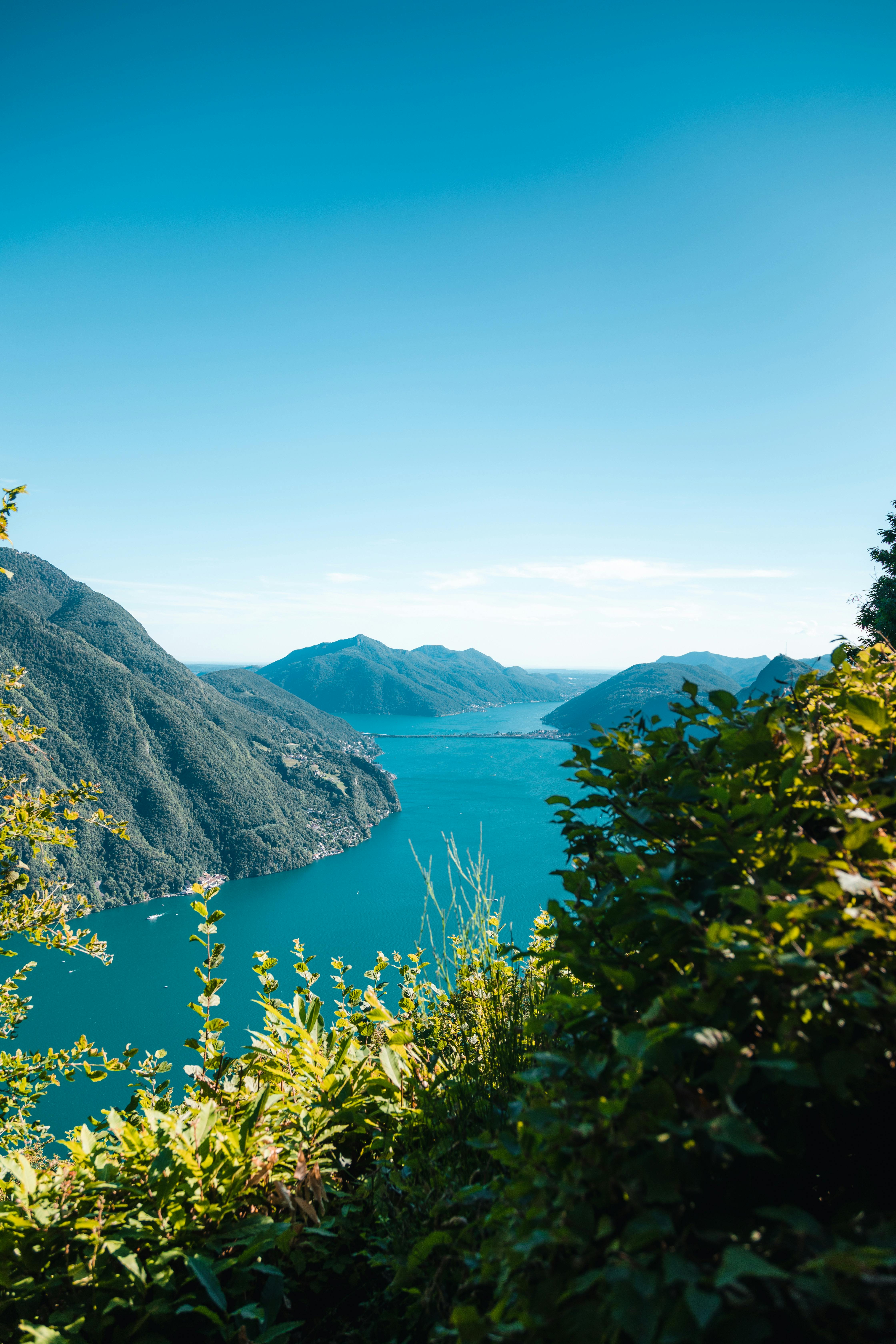 green mountains near body of water