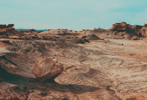 Free Captivating view of a desert landscape featuring unique rock formations under a clear blue sky. Stock Photo