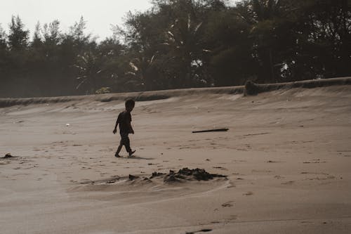 A Boy Walking on the Beach