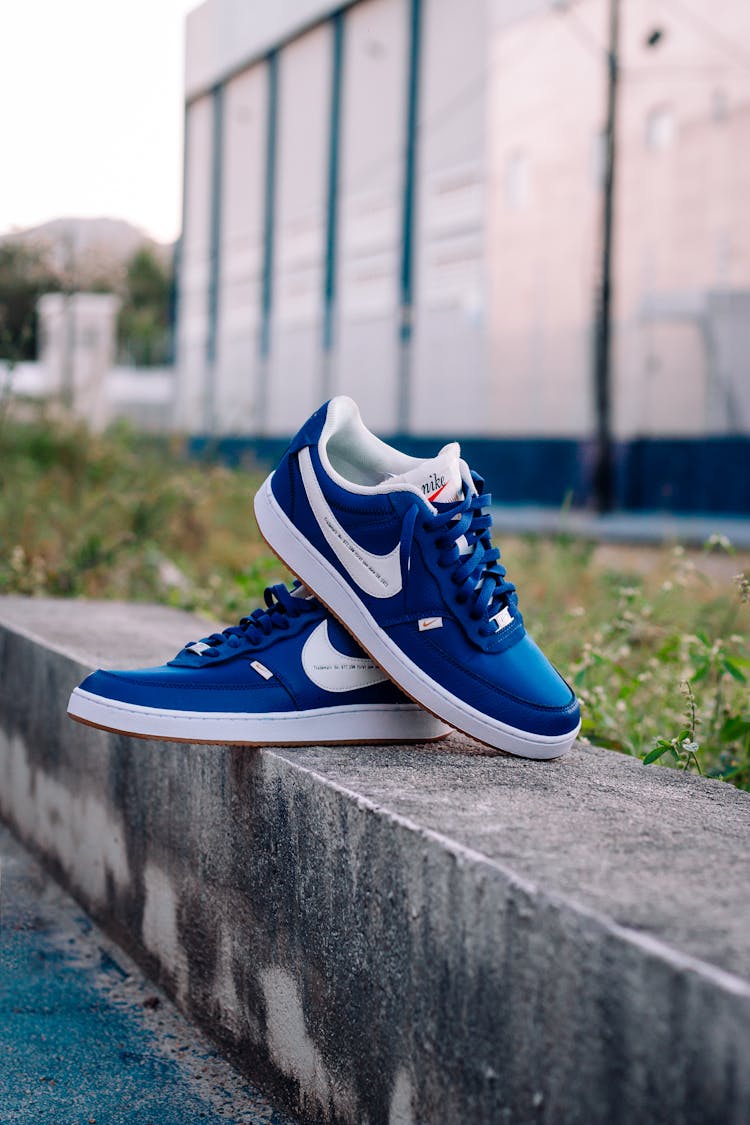 Blue And White Nike Sneakers On Concrete Bench
