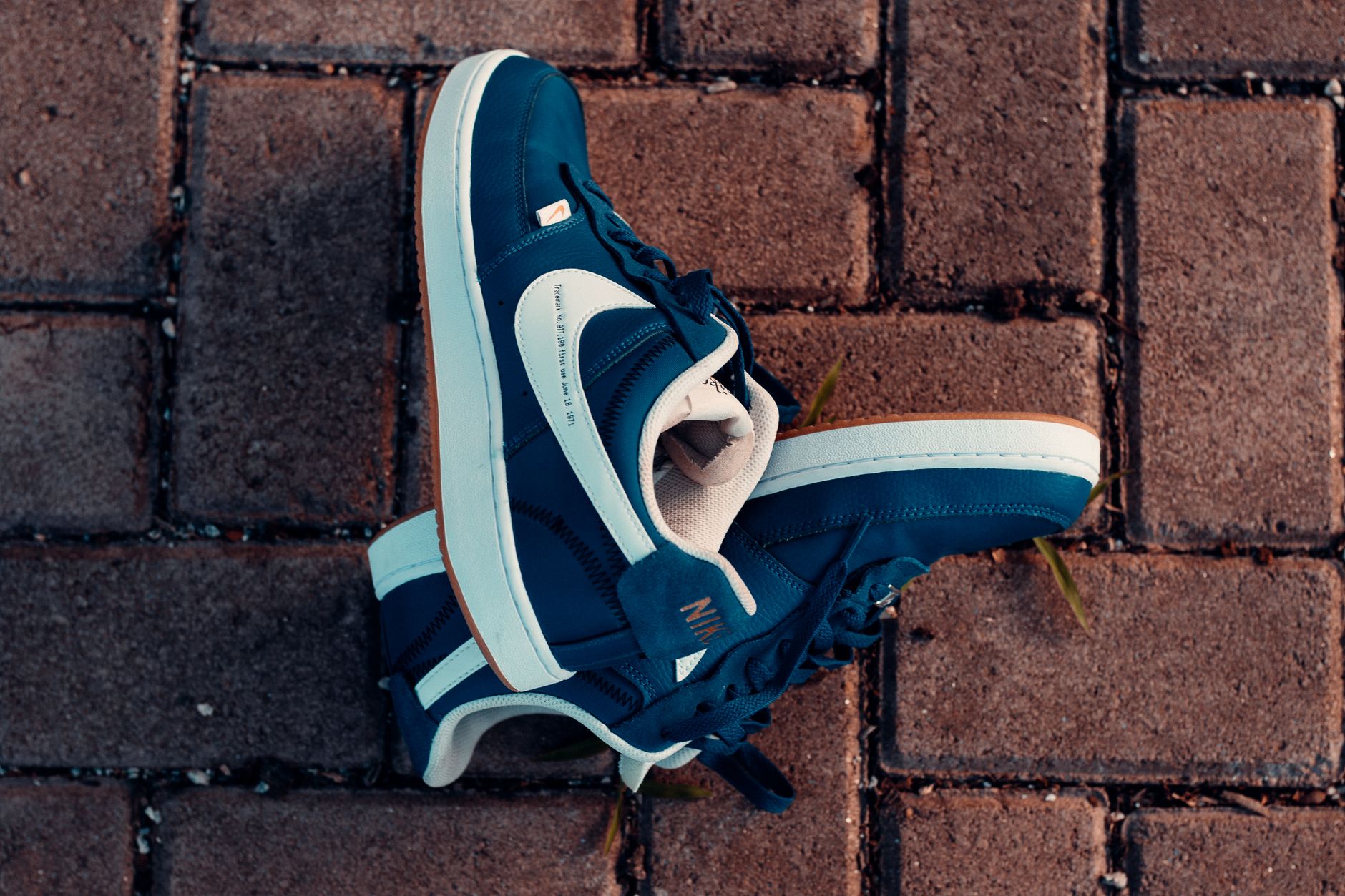 Close-up of blue sneakers on a brick pavement, highlighting urban street style in Maracanaú, Brazil.