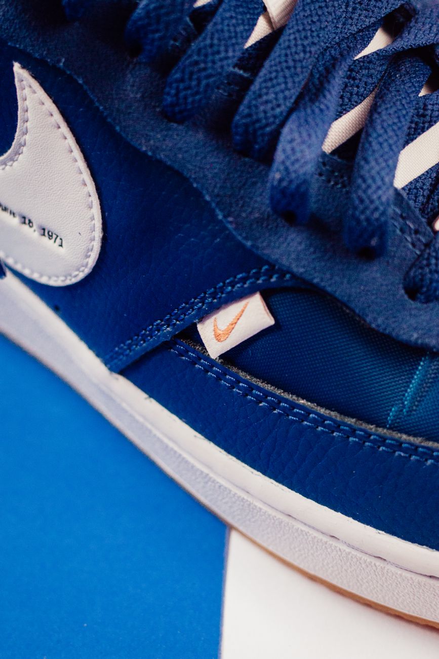 Detailed close-up shot of a blue Nike sneaker showcasing design elements and logo.