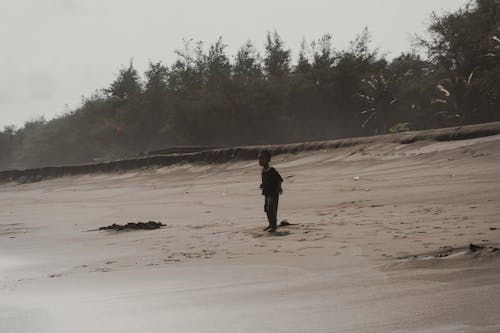 A Boy Standing on the Beach