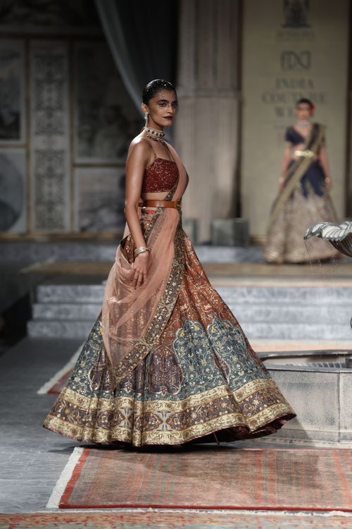 Free Model showcasing a traditional Indian lehenga on the runway at India Couture Week in New Delhi. Stock Photo