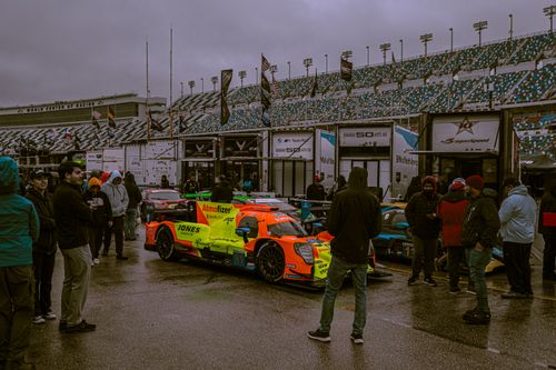 Free Vibrant race cars and fans at Daytona racetrack on a cloudy day. Stock Photo
