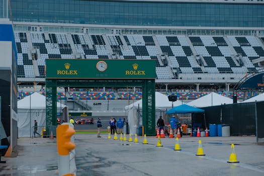 Exciting scene at Daytona Speedway with Rolex sponsorship during a race event.