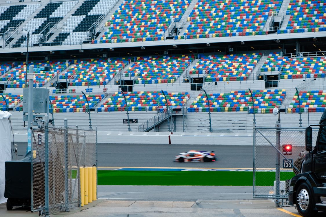 Car Racing Bleachers Fast Moving Car on a Race Track · Free Stock Photo